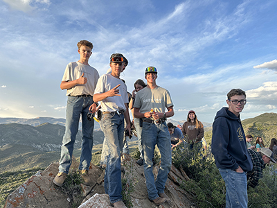Youth standing on top of the fossil mountain.